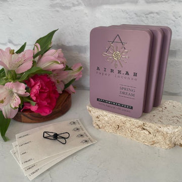 Spring Dream Paper Incense lilac tin containing 48 natural strips. Scented with musk, sandalwood, herbs, and jasmine. Ideal for meditation and intention setting, offering a clean burn and 100% natural ingredients.